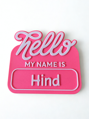 Pink name tag with 'Hello My Name is Hind' text on a white background