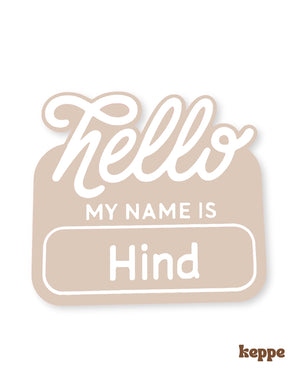 Name tag with 'Hello My Name is Hind' text on a beige background