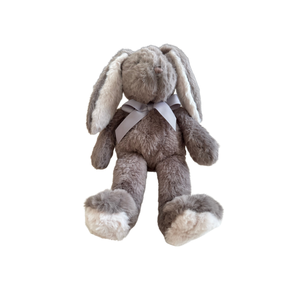 Plush toy rabbit with a white bow on a white background