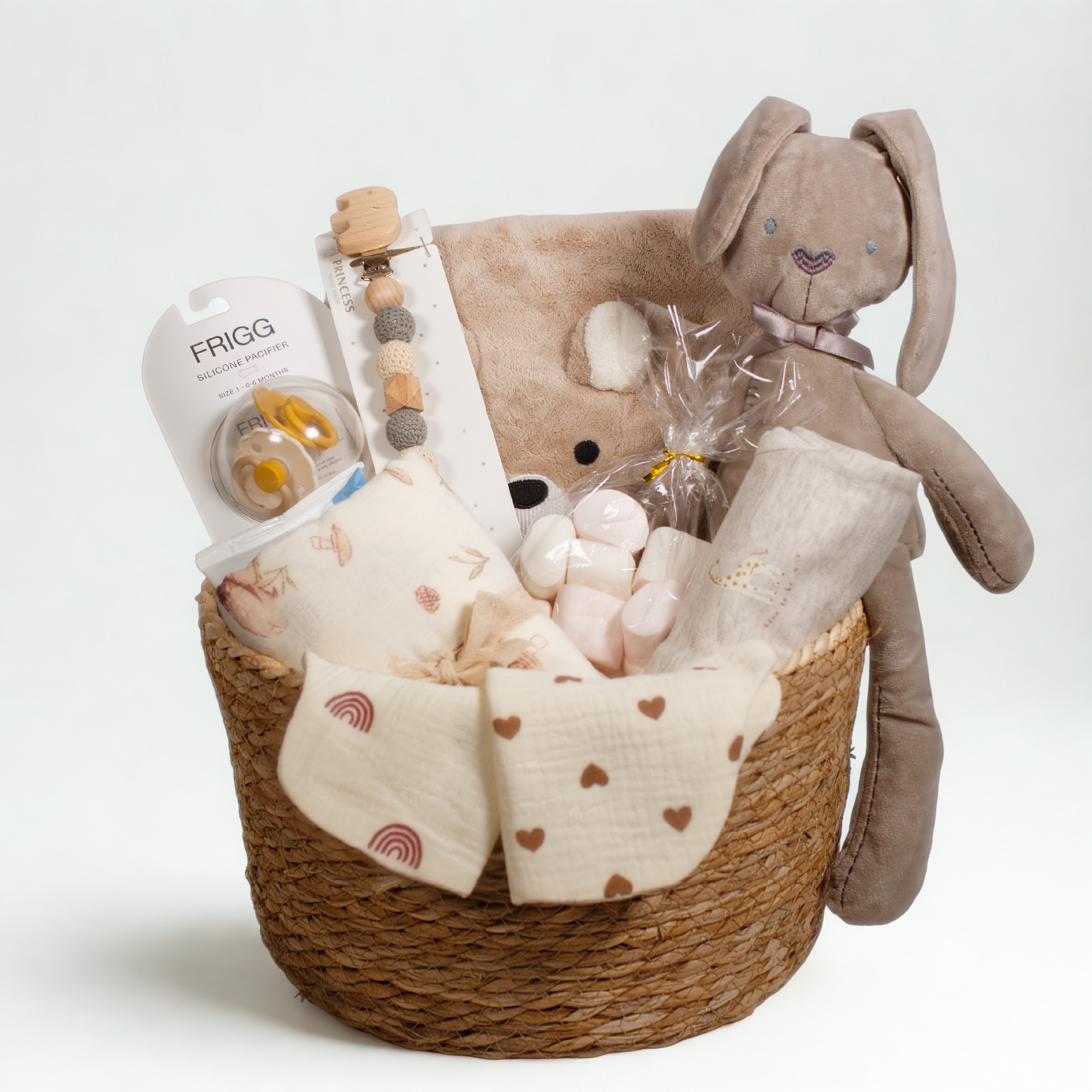 Baby gift basket with plush toys and baby items on a white background