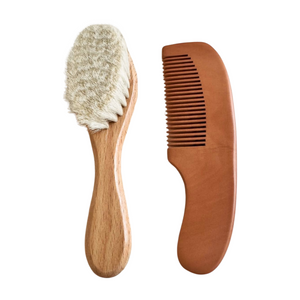 Wooden brush with bristles and wooden comb on a white background