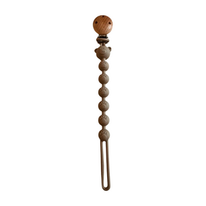 Decorative hair clip with wooden top and beaded body on a white background