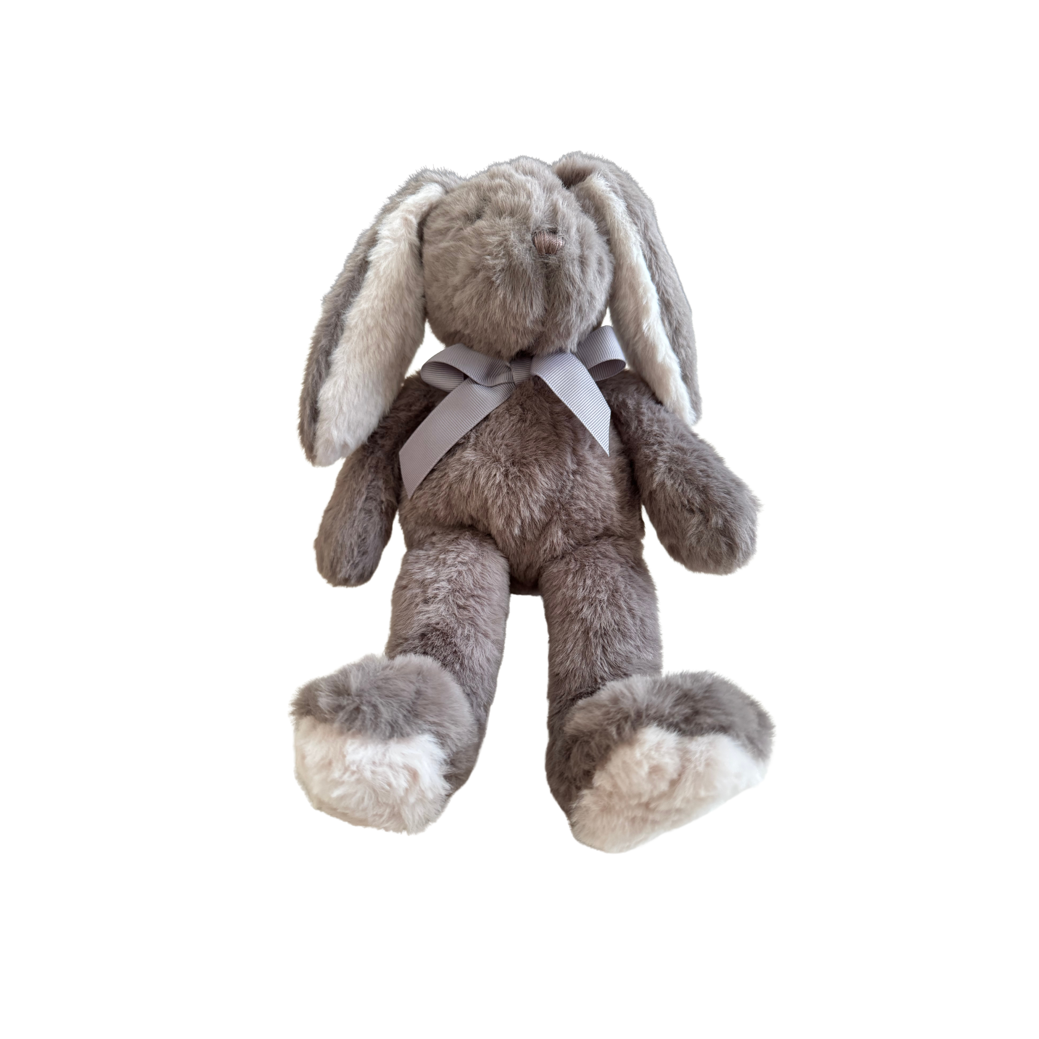 Plush toy rabbit with a white bow on a white background