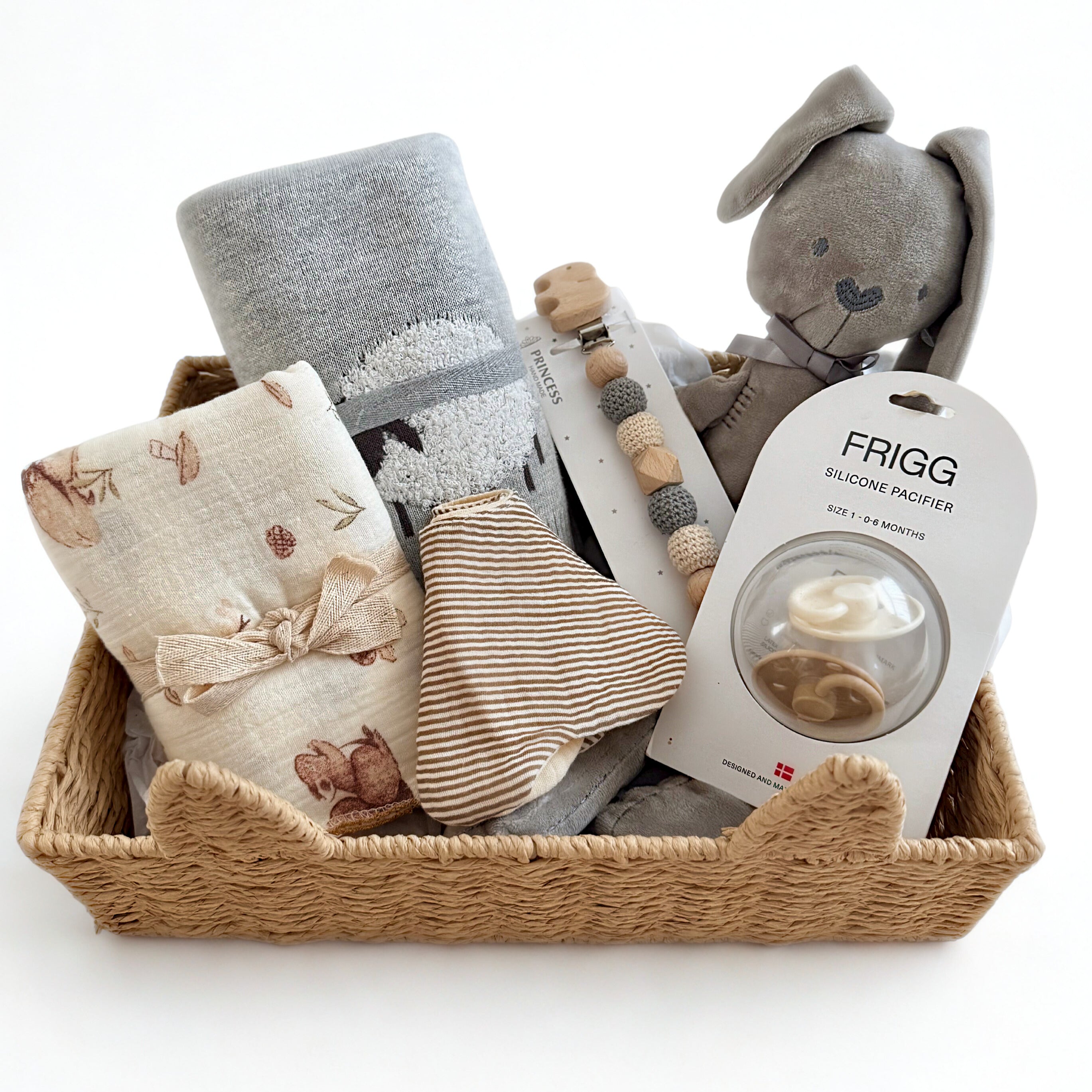Baby gift basket with plush toy, blanket, and pacifier on a white background